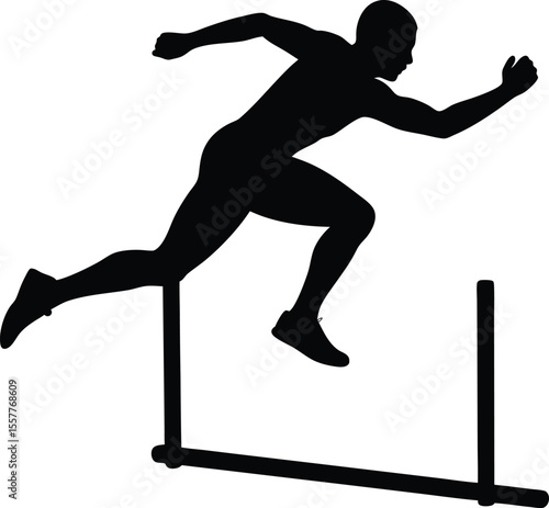 Silhouette of a male athlete jumping over a hurdle in a race