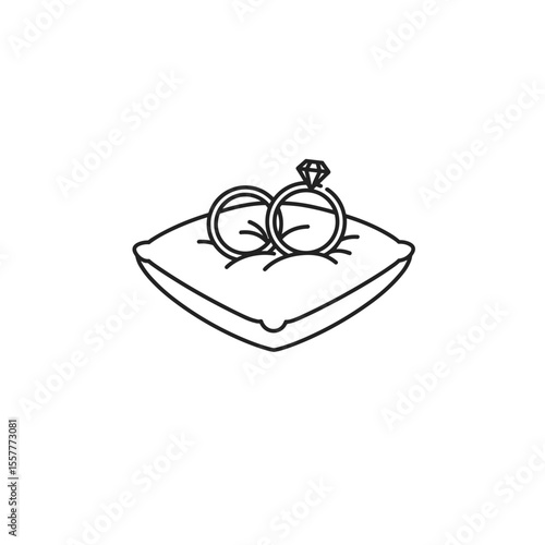 Wedding rings resting on a decorative pillow in minimalist style  