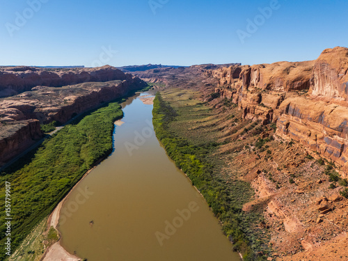 Beautiful Colorado River Through Red Desert Landscape With Towering Sandstone Canyon in Moab Utah