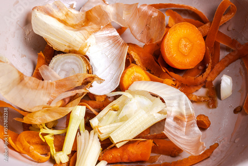 Peels from vegetables, peels from onions, carrots in a bowl. Food waste. Disposal of household food waste