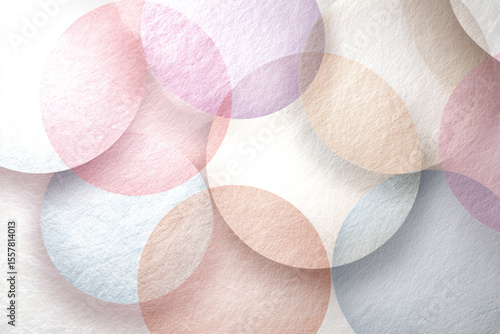 Colorful overlapping circles create a soft, abstract pattern on a textured surface in a serene setting