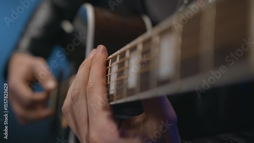 The guitarist is playing a barre chord