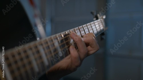 The guitarist gently fingerpicks the strings