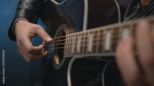 The guitarist's hand is playing the guitar