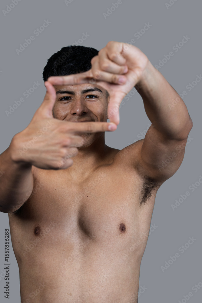 Fototapeta premium Shirtless man making a frame with his hands