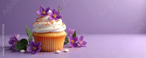 Cupcake with frosting flowers sprinkles on purple background. Dessert, sweet food for celebration birthday. Floral decoration, festive food design. Horizontal, copy space for text or logo.