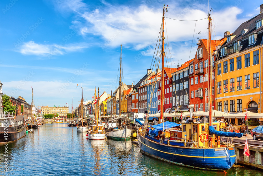 Fototapeta premium Famous old Nyhavn port in the center of Copenhagen, Denmark during summer sunny day. Copenhagen iconic view.