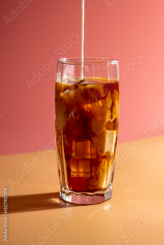 Wallpaper Mural Milk pouring into ice coffee on pink background. Torontodigital.ca