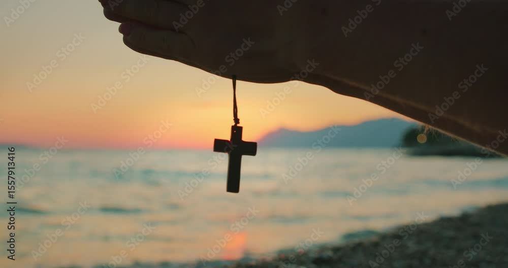custom made wallpaper toronto digitalHand holding a wooden cross necklace in front of the sea during peaceful sunset