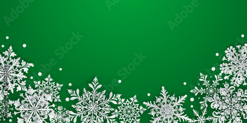 Christmas illustration featuring intricate paper snowflakes of varying sizes and designs located below, white on green background.