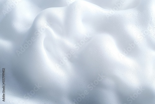 Close-up of dense white foam bubbles with soft shadows and light reflections creating smooth texture