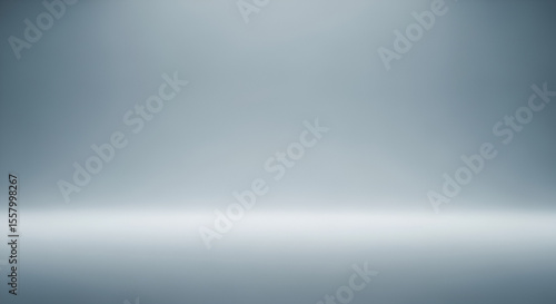 Empty gray studio room background with a smooth gradient wall. Abstract backdrop illuminated by a soft spotlight, ideal for product display.