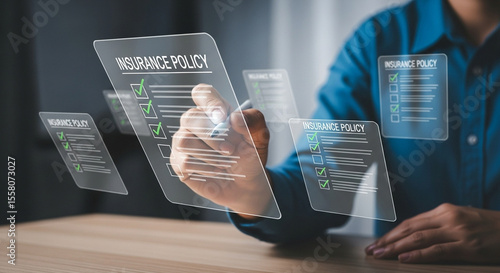 Man reviewing insurance policy checklist on transparent screens with a stylus pen in his hand
