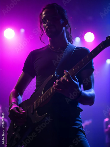 Man playing guitar in a music studio with focus on his hands and strings