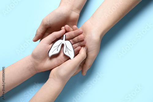 Child and adult hands holdi...