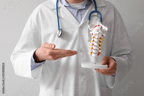 Doctor in white coat holdin...