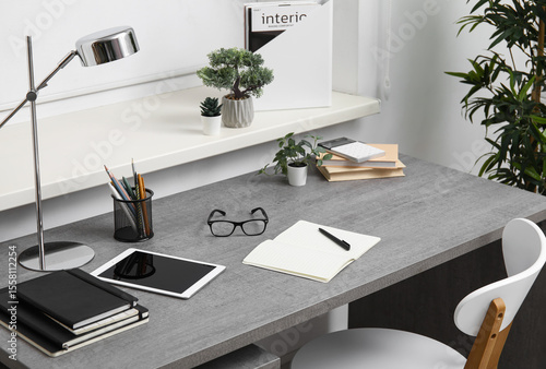 Stylish workplace with tabl...