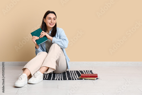 Young woman sitting on floo...