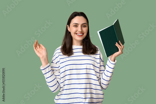 Young woman holding book on...