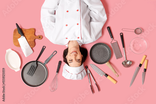 Happy young female cook wit...