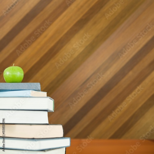 Canvastavla Green apple on pile of books