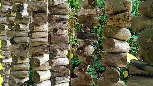 A decorative curtain made from dried tree branches, artistically arranged to create a natural and rustic look. This handmade piece adds a touch of organic charm and earthy texture to any space.