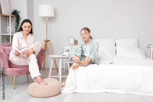 Young women in pajamas with...