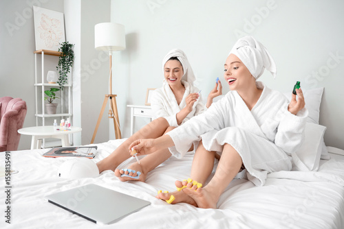 Young women in bathrobe wit...