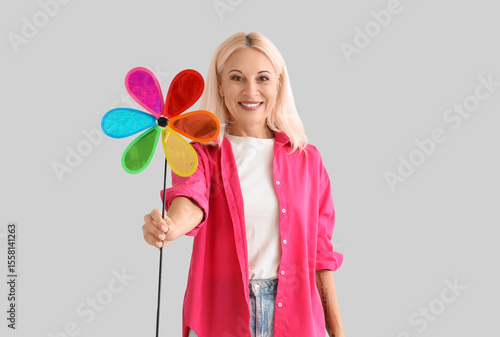 Mature woman with toy windm...