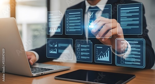Man analyzes data with holographic interfaces on his laptop representing business intelligence for data driven decisions, insights and strategy.