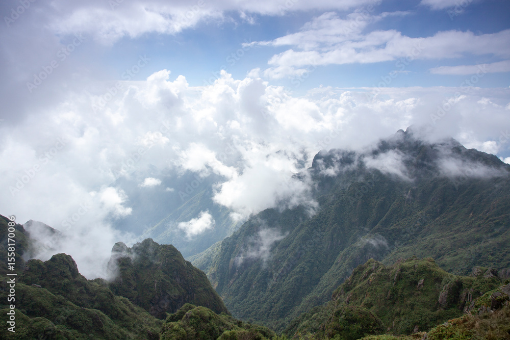Landscape of Morning Mist with Mountain Layer. mountain ridge and clouds in rural jungle bush forest Landscape of Morning Mist with Mountain Layer. mountain ridge and clouds in rural jungle bush forest