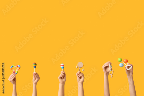 Hands holding baby toys on ...