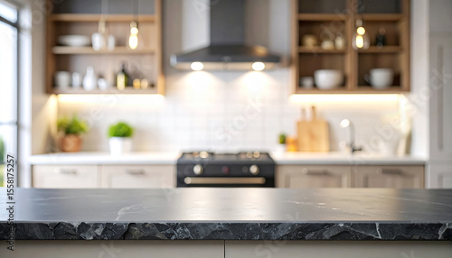 Close-up of a rough black slate board on the countertop against a blurry background in a modern bright kitchen.