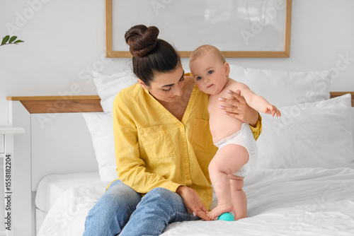 Mother massaging her little...