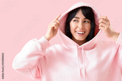 Young woman in hoodie with ...