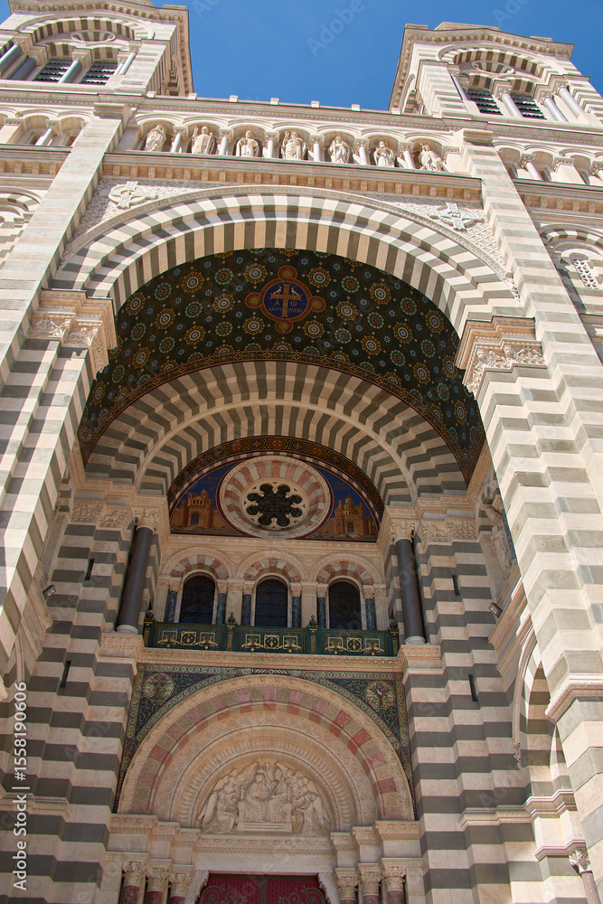 Obraz premium Domes and towers of the Marseille Cathedral of Sainte-Marie-Majeure in the La Joliette district, neo-Byzantine architecture under a blue sky
