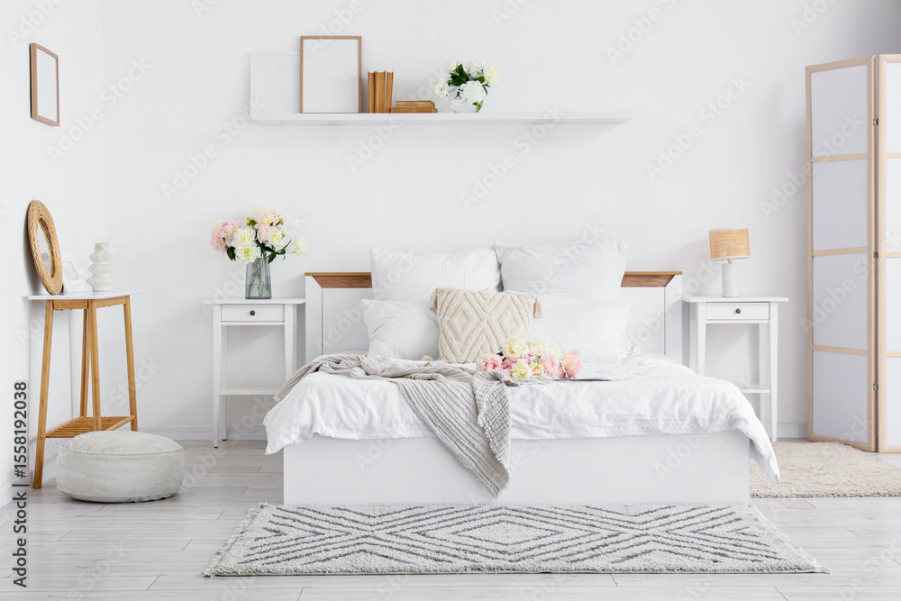 Interior of stylish bedroom with cozy bed and beautiful peonies Interior of stylish bedroom with cozy bed and beautiful peonies