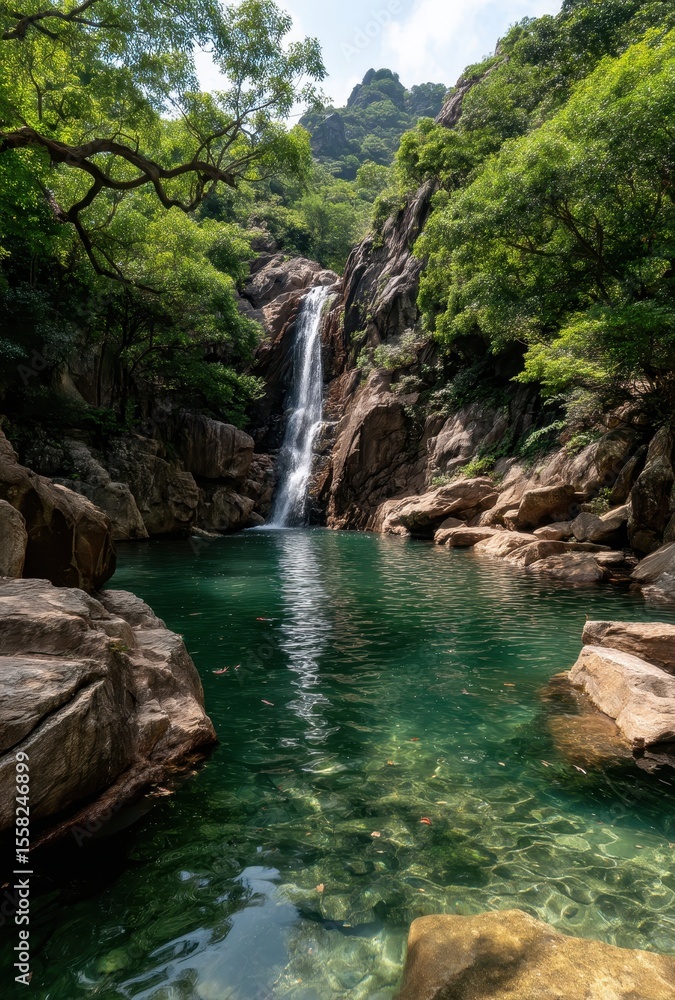 Naklejka premium Serene Tropical Waterfall Cascading into Crystal Clear Pool Surrounded by Lush Green Forest and Majestic Rock Formations in a Peaceful Setting