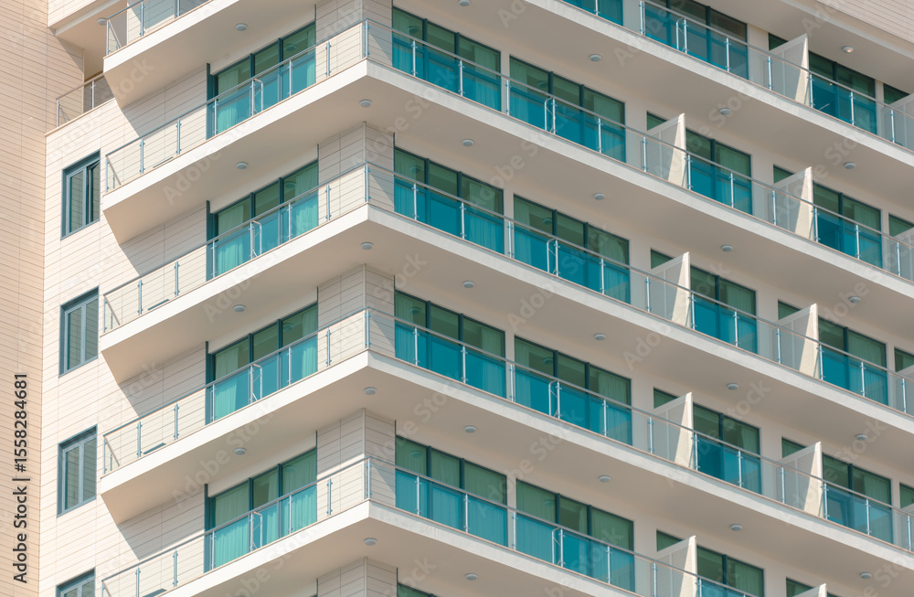 A tall building with a lot of windows and balconies A tall building with a lot of windows and balconies
