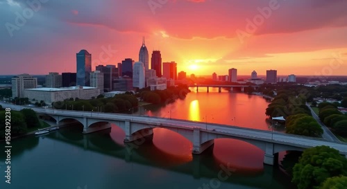 skyline indianapolis indiana sunset bridge spanning body water vehicles road trees light poles buildings