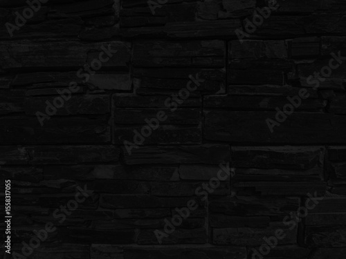 Enigmatic Black Stone Wall: Textured and Tightly Stacked Stones for a Modern Minimalist Background