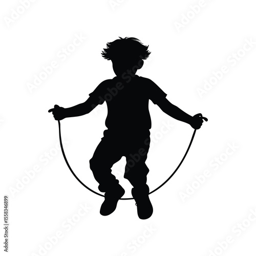 Silhouette of a playful boy skipping rope with joy and happiness outdoors