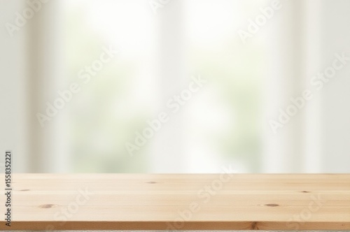 A wooden table with a blurred window in the background