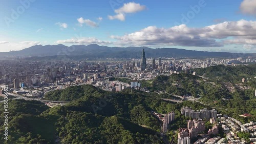 Aerial Panorama of Spire-Topped Skyscraper in Mountainous Taipei Urban Landscape