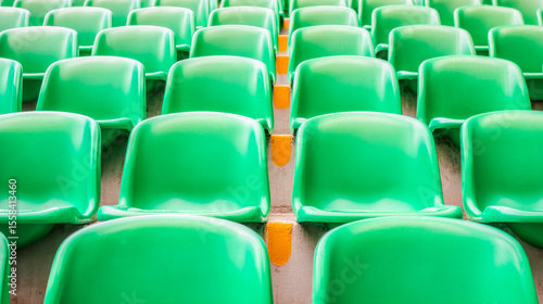 Vibrant green stadium seats in organized rows with modern design and bright lighting