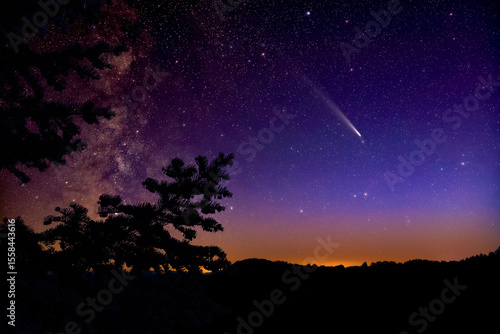 Milky Way stars, comet and rural countryside tree silhouettes