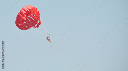 two man parasailing with parachute