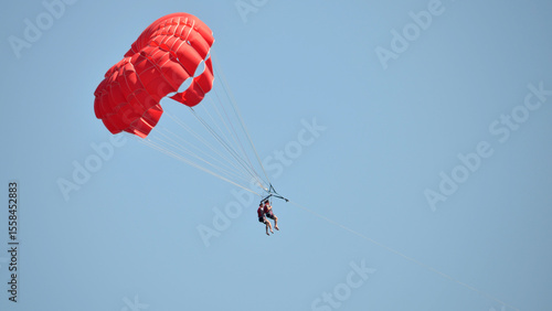 two man parasailing with parachute