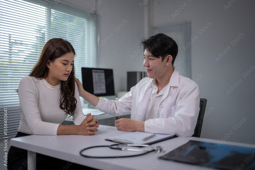 woman is sitting at a desk with a doctor woman is sitting at a desk with a doctor