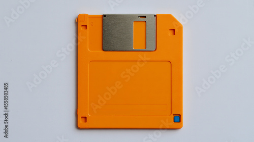 Orange Diskette: A detailed, high-angle shot of a single, iconic orange floppy disk, the image captures the essential characteristics of this vintage storage device.